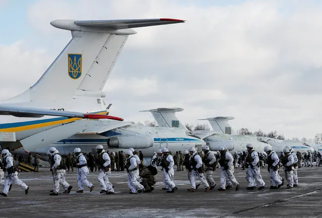 Ukrainian paratroopers approach military planes before departing to the eastern regions of the country on mission at an airforce base near Zhytomyr, Ukraine December 6, 2018. (Photo by Gleb Garanich/Reuters)
