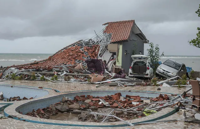 Debris littered a property badly damaged by a tsunami in Carita, Indonesia, Sunday, December 23, 2018. The tsunami occurred after the eruption of a volcano around Indonesia's Sunda Strait during a busy holiday weekend, sending water crashing ashore and sweeping away hotels, hundreds of houses and people attending a beach concert. (Photo by Fauzy Chaniago/AP Photo)