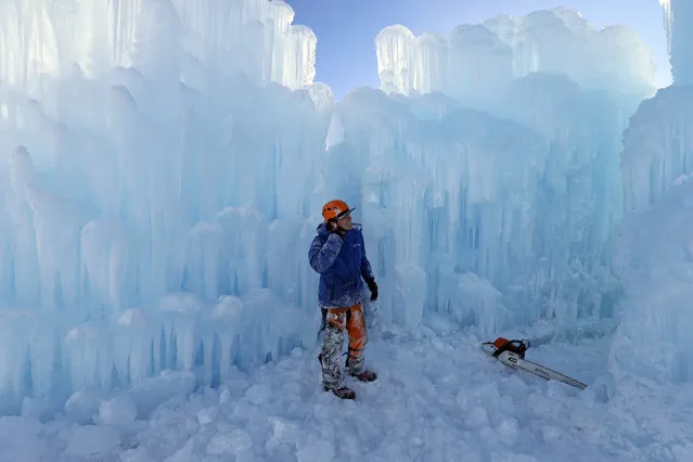 Midway Ice Castles take shape as artisans construct popular winter attraction Wednesday, January 2, 2019, in Midway, Utah. A winter storm has covered cactus with snow in parts of the American Southwest as temperatures in the desert fall below those of Anchorage, Alaska. (Photo by Rick Bowmer/AP Photo)