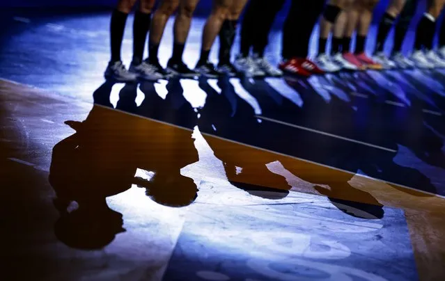 Shadows of Ukrainian players are casted before the IHF Women's World Handball Championship Group G match between Ukraine and Kazakhstan in Frederikshavn, Denmark, 03 December 2023. (Photo by Hannibal Hanschke/EPA/EFE)