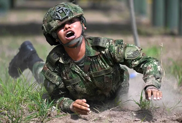 A female soldier takes part in a training for women at the Tolemaida Military Air Base in Tolemaida, Colombia, on May 16, 2023. The last time the Colombian Army enlisted women in their ranks was in 1993. Now, 30 years on, more than 1,200 women voluntarily joined the military service in the country. (Photo by Raúl Arboleda/AFP Photo)