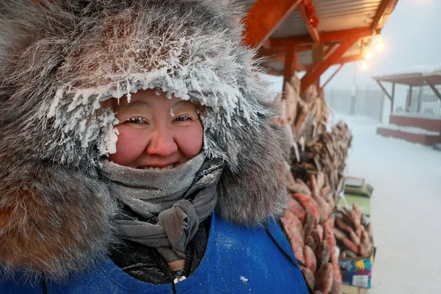 Vendor Nyurgusun Starostina, 47, poses for a picture at an open-air market on a frosty day in Yakutsk, Russia, December 5, 2023. Temperatures in parts of the Sakha Republic, also known as Yakutia and located in the northeastern part of Siberia, went below minus 50 degrees Celsius (minus 58 degrees Fahrenheit) on December 5. (Photo by Roman Kutukov/Reuters)
