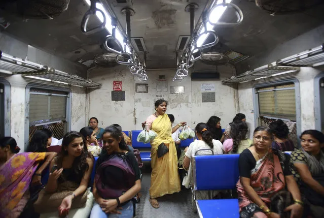 A vendor sells vegetables inside the Ladies' Special train in Mumbai, December 6, 2012. (Photo by Navesh Chitrakar/Reuters)