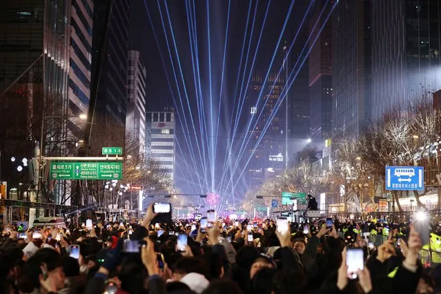 People attend a ceremony to celebrate the new year in Seoul, South Korea on January 1, 2024. (Photo by Kim Hong-Ji/Reuters)