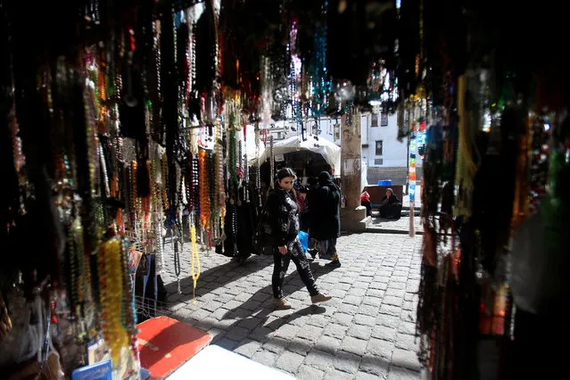 A woman walks along a stall with prayer beads displayed for sale in Damascus, Syria January 27, 2017. (Photo by Ali Hashisho/Reuters)