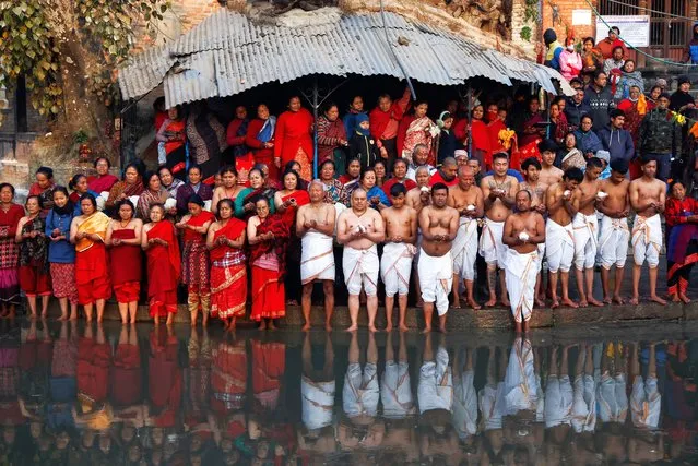 Devotees gather as they offer prayer on the bank of the Hanumante river during the month-long Swasthani Brata Katha festival in Bhaktapur, Nepal on January 29, 2024. (Photo by Navesh Chitrakar/Reuters)