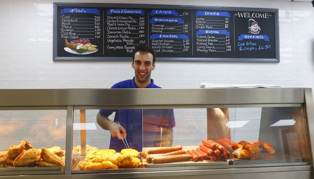 Salih Yilcim, 28, poses for a photograph at his workplace, Big Bite Fish and Chip Shop, in the London constituency of Brent Central, Britain, April 3, 2015. Yilcim was born in England, his parents are from Ireland and Cyprus. He said: “England is a disgrace in the way the government look after old people. In this job I've learnt a real respect for old people. They should be looked after much better”. (Photo by Eddie Keogh/Reuters)