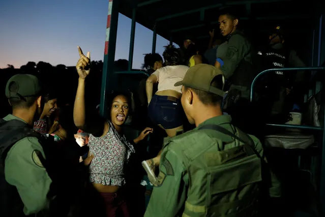 Detainees get on a truck after they were caught looting during an ongoing blackout in Caracas, Venezuela March 10, 2019. (Photo by Carlos Garcia Rawlins/Reuters)