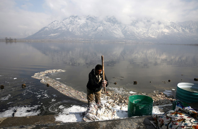 A Kashmiri washerman washes clothes on a sunny day at the banks of Nageen Lake in Srinagar, the summer capital of Indian Kashmir, 06 February 2017. Kashmir witnessed sunny day while “medium danger” avalanche warning was issued for upper reaches and avalanche prone-areas in Indian Kashmir. (Photo by Farooq Khan/EPA)