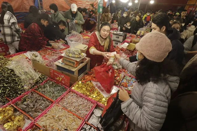 People shop for the upcoming Lunar New Year celebrations at the Dihua street market in Taipei, Taiwan, Thursday, February 8, 2024. Taiwanese shoppers started hunting for delicacies, dried goods and other bargains at the market ahead of the Lunar New Year celebrations which fall on Feb. 10 this year. (Photo by Chiang Ying-ying/AP Photo)