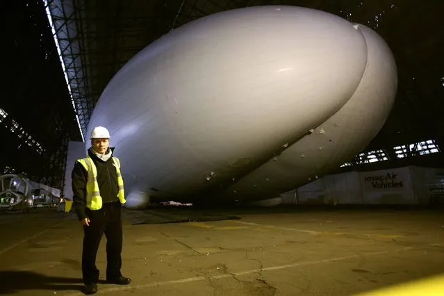 Iron Maiden front man Bruce Dickinson stands alongside the world's largest aircraft known as the HAV304, at its launch at Cardington Hanger in Bedfordshire, on February 28, 2014. (Photo by Chris Radburn/PA Wire)
