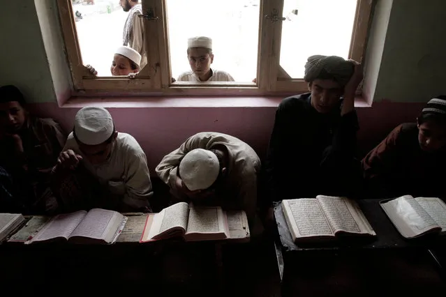 Afghan boys read the Quran during the Muslim holy month of Ramadan at a mosque on the outskirts of Kabul, Afghanistan, Tuesday, July 16, 2013. Ramadan is the holiest month in Islam and Muslims worldwide observe it by fasting. (Photo by Rahmat Gul/AP Photo)
