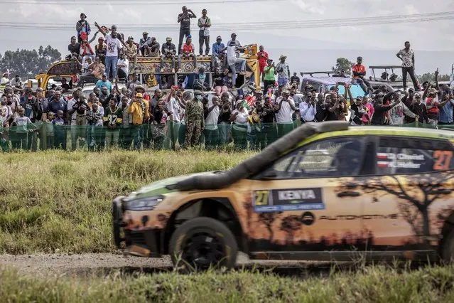 Spectators gather to watch from the sidelines as Polish driver Daniel Chwist steers his Skoda Fabia RS with Polish co-driver Kamil Heller during the World Rally Championship (WRC) Safari Rally Kenya Special Stage 16 (SS16) in Naivasha, on March 31, 2024. (Photo by Luis Tato/AFP Photo)