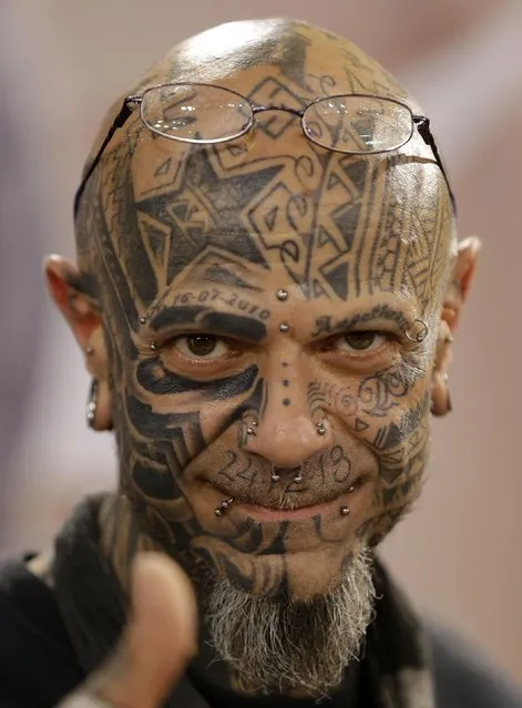 A heavily tattooed man makes a thumb up sign during the annual Athens Tattoo Convention in Athens, Sunday, May 17, 2015. About 230 artists from Greece and abroad took part in the three-day event attracted thousands of visitors. (Photo by Thanassis Stavrakis/AP Photo)
