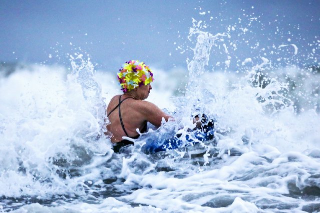 The ladies of the Rother Bobbers open water swimming group take a chilly Winter Solstice sunrise swim in the choppy seas at Langland Bay, Swansea, Wales, United Kingdom on December 21, 2022. (Photo by Joann Randles/Cover Images)
