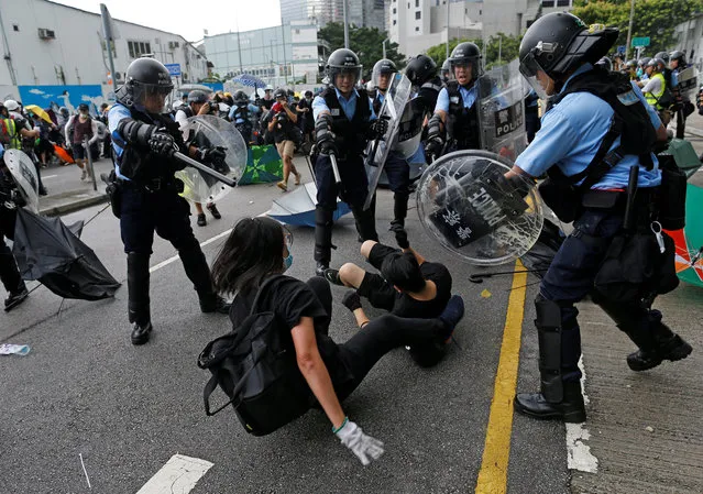 Riot police try to disperse protesters near a flag raising ceremony for the anniversary of Hong Kong handover to China in Hong Kong, China on July 1, 2019. (Photo by Thomas Peter/Reuters)