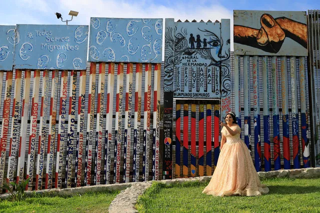 A girl poses in her quinceanera dress near the border fence between Mexico and U.S. in Tijuana, Mexico on  July 18, 2019. (Photo by Carlos Jasso/Reuters)