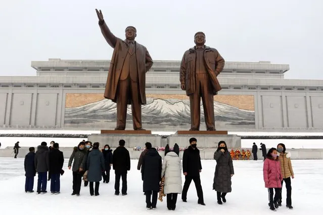 People visit the statues of former North Korean leaders Kim Il Sung, left, and Kim Jong Il on Mansu Hill in Pyongyang, North Korea, on the occasion of Lunar New Year holidays on Tuesday, February 1, 2022. (Photo by Jon Chol Jin/AP Photo)