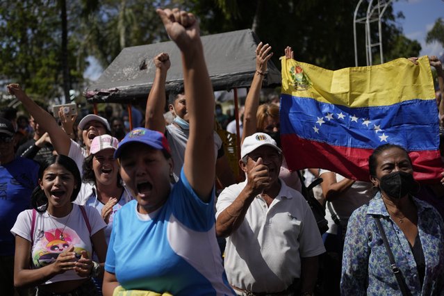 Supporters of opposition governor-elect of Barinas state, Sergio Garrido, rally outside a church after attending Mass with Garrido the day after elections in Barinas, Venezuela, Monday January 10, 2022. (Photo by Matias Delacroix/AP Photo)