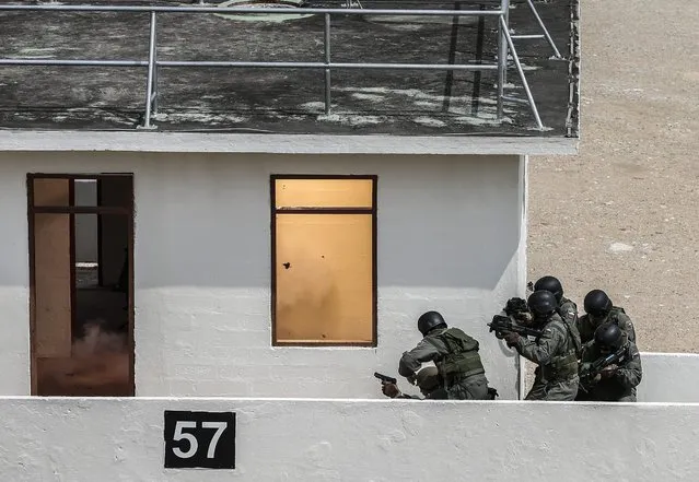 A “flashbang”, thrown by special forces soldiers, explodes in a room, during a counter terrorism exercise in an urban operations training facility in Singapore, 09 May 2016. Singapore is hosting the ASEAN Defence Minister's Meeting (ADMM) which involves combined operations between special forces units from the ten ASEAN member countries as well as India, South Korea, China, Japan, Russia, USA, Australia and New Zealand. The exercise was the first counter-terrorism exercise to be held under the ADMM-Plus framework of countries. (Photo by Wallace Woon/EPA)