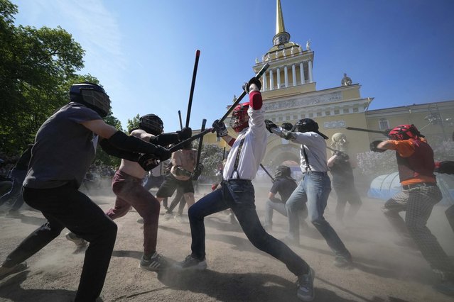 Russian members of Irish stick fighting club, participants of a fencing show, fight during celebrations of the 321st anniversary of St. Petersburg, in St. Petersburg, Russia, Sunday, May 26, 2024. (Photo by Dmitri Lovetsky/AP Photo)