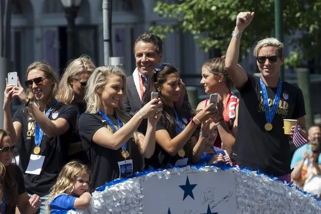 U.S. women's soccer star Abby Wambach (R) rides a float with some of her team mates during the ticker tape parade up Broadway in lower Manhattan to celebrate their World Cup final win over Japan in New York, July 10, 2015. (Photo by Mike Segar/Reuters)