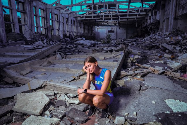 Kateryna Tabashnyk, a high jumper, sits for a portrait Sunday, June 9, 2024, at the athletics arena of the "Polytechnic" sports complex, which was destroyed by a Russian rocket attack, in Kharkiv, Ukraine. On the eve of the war, which started February 24, 2022, Ukraine cancelled its athletics championship and Tabashnyk was in Kharkiv. The threat posed by thousands of Russian troops at the border, just 20 kilometers (12 miles) from her hometown, was real. But Tabashnyk said, “I was 100% sure that this could not happen”. (Photo by Evgeniy Maloletka/AP Photo)