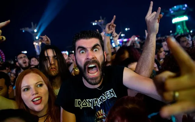 Fans of the Brazilian heavy metal band Sepultura enjoy their showo at the main stage of Rock in Rio festival 2019 at the Olympic Park, Rio de Janeiro, Brazil, on October 4, 2019. The week-long Rock in Rio festival started September 27, with international stars as headliners, over 700,000 spectators and social actions including the preservation of the Amazon. (Photo by Mauro Pimentel/AFP Photo)