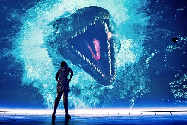 Real Ideas staff member, Cat Edwards, watches a massive sea monster as she checks audio and visual levels on a huge 360 dome at Devonport's Market Hall in Plymouth, southwest England on Thursday July 15, 2021, where the first audiences are preparing to enter the new £7.6 million immersive dome, which is the first of its type to be built in Europe. (Photo by Ben Birchall/PA Images via Getty Images)