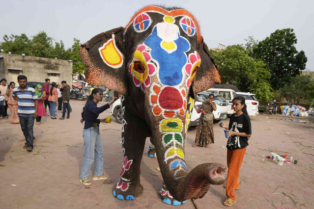 Girls paints decorative motifs on an elephant on the eve of the annual Rath Yatra, or chariot procession of Lord Jagannath, at Jagannath temple in Ahmedabad, India, Saturday, July 6, 2024. (Photo by Ajit Solanki/AP Photo)