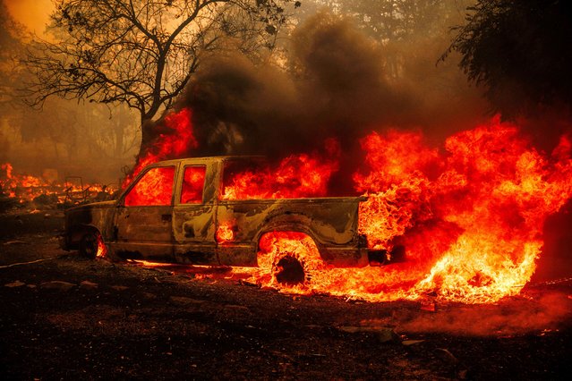 A property is engulfed in flames as the Thompson Fire burns, Tuesday, July 2, 2024, in Oroville, Calif. (Photo by Ethan Swope/AP Photo)