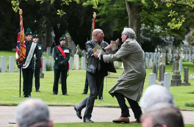 Canadian Ambassador to Ireland, Kevin Vickers, right, wrestles with a protester who attempted to disrupt a State ceremony at Grangegorman Military Cemetery to remember the British soldiers who died during the Easter Rising, Dublin, May 26, 2016. (Photo by Brian Lawless/PA Wire via AP Photo)