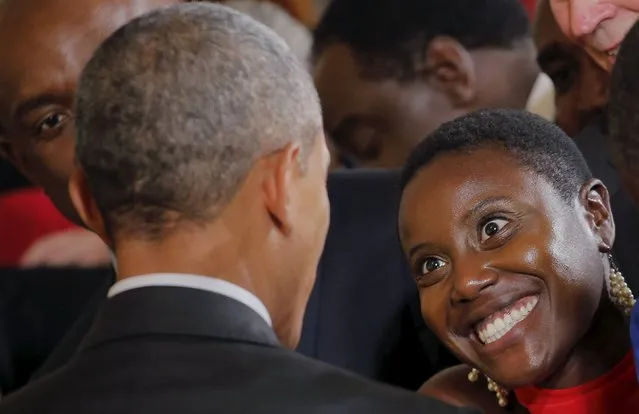 A guest smiles at U.S. President Barack Obama after the president delivered remarks at a reception celebrating the signing into law of the African Growth and Opportunity Act at the East Room of the White House in Washington July 22, 2015. (Photo by Carlos Barria/Reuters)