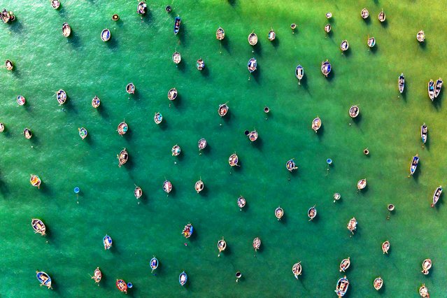 This aerial picture taken on June 29, 2024 shows fishing boats moored at a beach in Danang, central Vietnam. (Photo by Dale De La Rey/AFP Photo)