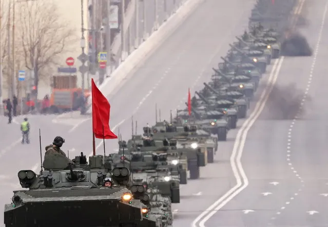 Russian service members drive armoured vehicles along the street before a rehearsal for the Victory Day military parade in Moscow, Russia on April 28, 2022. (Photo by Maxim Shemetov/Reuters)