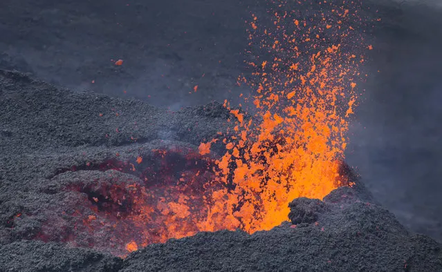 Lava erupts from the Piton de la Fournaise “Peak of the Furnace” volcano, on the southeastern corner of the Indian Ocean island of Reunion Saturday, August 1, 2015. (Photo by Ben Curtis/AP Photo)
