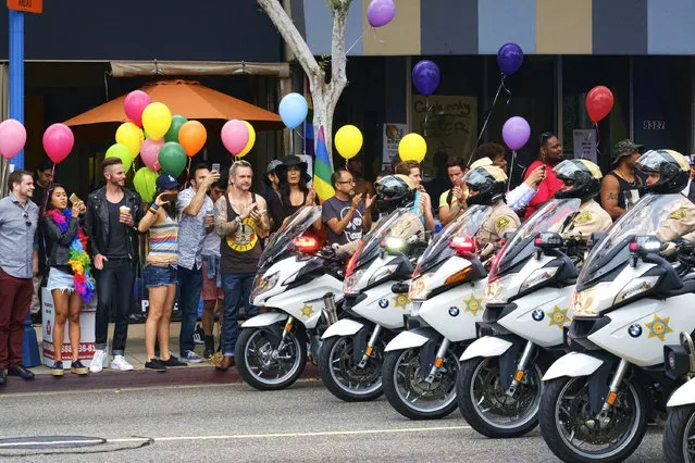 Los Angeles County Sheriff's department motorcycle deputies ride along a street in West Hollywood, Calif., during the Gay Pride Parade on Sunday, June 12, 2016. A heavily armed man arrested in Southern California told police he was in the area for West Hollywood's gay pride parade. (Photo by Richard Vogel/AP Photo)