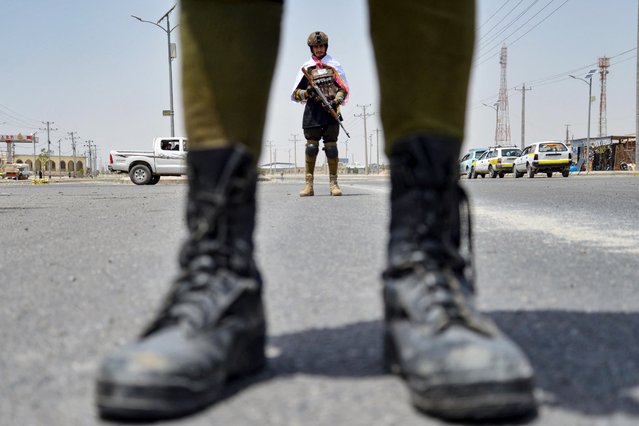 Taliban security personnel stand guard at a checkpoint in Kandahar on August 13, 2024, on the eve of the third anniversary of Taliban's takeover of Afghanistan. (Photo by Sanaullah Seiam/AFP Photo)