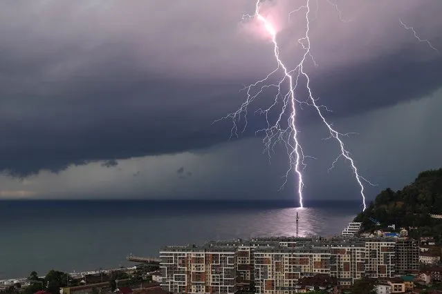 A lightning bolt is seen over the Black Sea off the resort village of Dagomys, Lazarevsky District in Sochi, Russia on September 21, 2021. (Photo by Vladimir Smirnov/TASS)