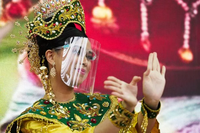 A dancer from Malaysia's pavilion performs wearing a face shield due to the coronavirus at Expo 2020, in Dubai, United Arab Emirates, Sunday, October 3, 2021. (Photo by Jon Gambrell/AP Photo)