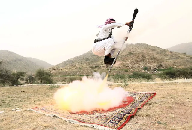 A man fires a weapon as he dances during a traditional excursion near Taif, Saudi Arabia August 8, 2015. (Photo by Mohamed Al Hwaity/Reuters)