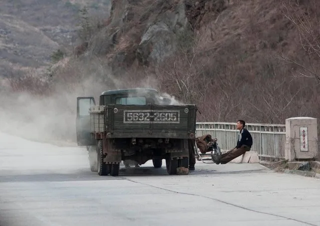 The kind of scene you can see along the highway. Overloaded trucks but broken down with lot of smoke coming out... I was allowed to make those pics as after lunch, my guides were enjoying the confort of the bus seats and snoring... (Photo by Eric Lafforgue/Exclusivepix Media)