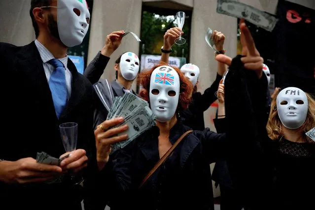 Activists attend an action “Debt for climate” to demand from the G7 the cancellation of the debt for countries of the Global South, in front of the International Monetary Fund (IMF) offices in Paris, France on June 27, 2022. (Photo by Sarah Meyssonnier/Reuters)