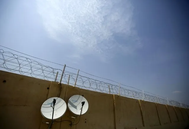 Satellite dishes are seen fixed on the boundary wall of the Jaisalmer Airport in desert state of Rajasthan, India, August 13, 2015. (Photo by Anindito Mukherjee/Reuters)