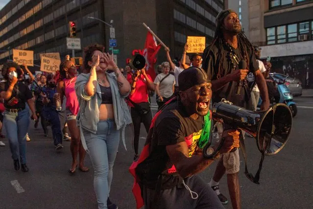 People march, during a protest for Jayland Walker, a black man killed by police officers in Akron, Ohio, and in protest of racist policing in New York, New York, USA, 06 July 2022. On 27 June 2022, Akron police officers shot Walker at least 60 times during a foot chase following an attempted traffic stop and car chase. (Photo by Sarah Yenesel/EPA/EFE)