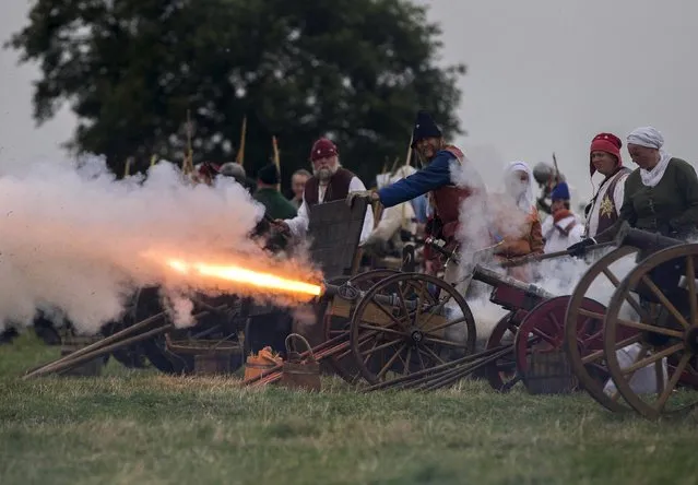 Historical re-enactors fire guns as they recreate the Battle of Bosworth at an anniversary event near Market Bosworth in central Britain, August 23, 2015. (Photo by Neil Hall/Reuters)
