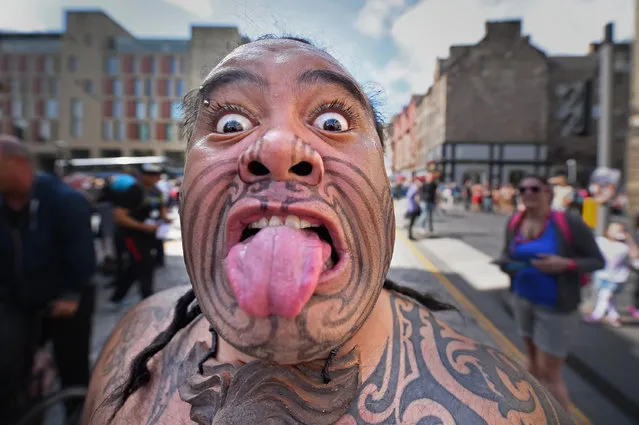 Te Matatini Kapa Haka Aotearoa perform the Haka at the Edinburgh Festival Fringe on the Royal Mile on August 14, 2014 in Edinburgh, Scotland. The largest performing arts festival in the world, this years festival hosts more than 3,000 shows in nearly 300 venues across the city. (Photo by Jeff J. Mitchell/Getty Images)