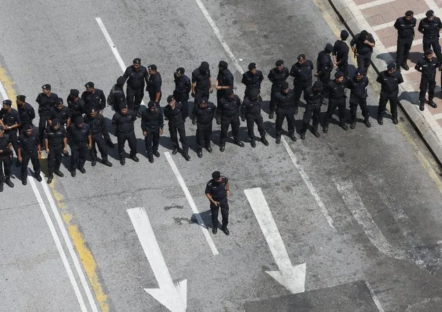 Police block a road ahead of a protest organised by pro-democracy group “Bersih” (Clean) in Malaysia's capital city of Kuala Lumpur, August 29, 2015. (Photo by Olivia Harris/Reuters)
