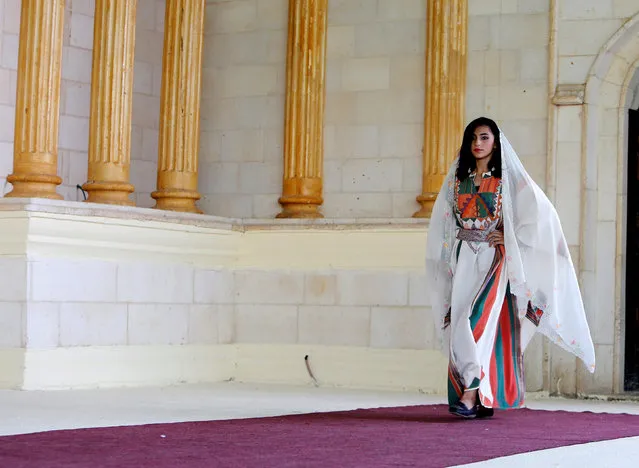 A Palestinian model displays a traditional Palestinian dress during a fashion show in celebration of Palestinian Traditional Dress and Heritage Day at Haddad village near the West Bank city of Jenin, July 25, 2016. (Photo by Abed Omar Qusini/Reuters)