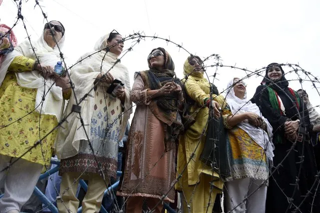 Supporters of former Pakistani Prime Minister Imran Khan's party gather outside an anti-terrorism court in Islamabad, Pakistan, Thursday, August 25, 2022. The court on Thursday extended Khan's protection from arrest through the end of the month, officials said, after police filed terrorism charges against the country's popular opposition leader. (Photo by W.K. Yousafzai/AP Photo)